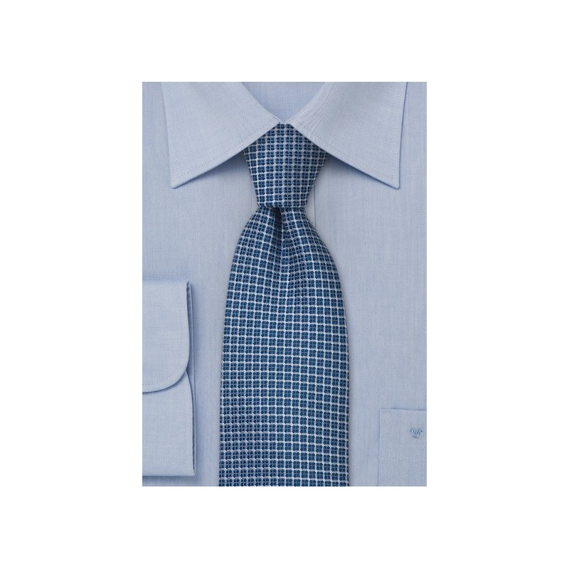 Blue silk tie with checkered pattern